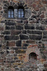 Windows in the stone wall of the castle, vertical picture