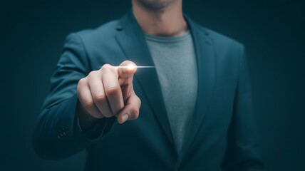 Fototapeta premium Man in a suit pointing with his finger towards the camera in a dark blue background studio shot