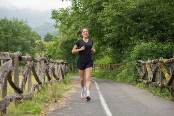 young and beautiful girl, running in a park in the middle of nature