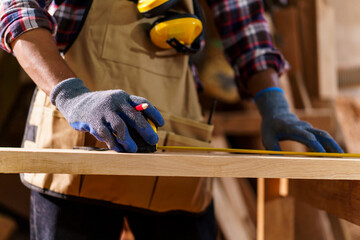 Professional African male carpenter is working professionally in sawmill - workshop.