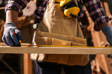 Professional African male carpenter is working professionally in sawmill - workshop.