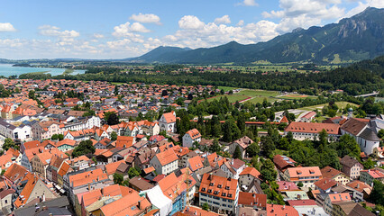 Fototapeta premium Fussen aerial panorama with alpine mountains, river, and historic town in Germany