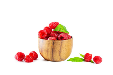 Ripe shiny raspberries with leaves in a wooden bowl isolated on a white background.