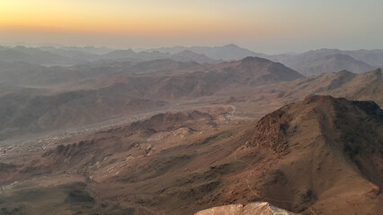 Sunset Over Desert Mountains with Orange and Purple Sky