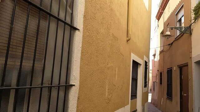 Badalona, Spain - May 18, 2022. View of the old street of Dalt la Vila, building with colourful facade, historic centre of Badalona, province of Barcelona, Spain.