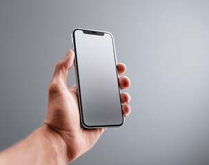 cropped shot of man holding smartphone with blank screen isolated on grey