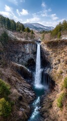 Fototapeta premium Waterfall cascading down rocky gorge (1)