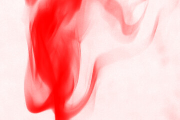 Vibrant crimson red smoke swirls and dances against a deep black background creating an abstract and energetic visual