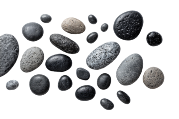 Assorted smooth stones, various shades of gray and black, scattered on a dark background