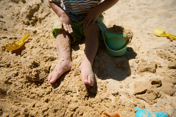 Child Playing With Sand Toys on a Sunny Beach