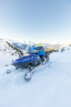 Snowmobiling adventure through snowy mountain terrain
