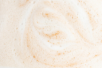 Macro coffee milk foam texture with light swirls