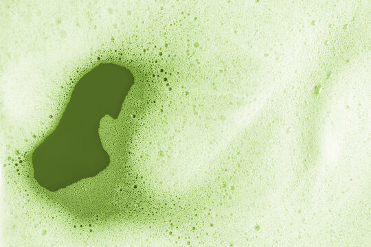 Macro capture of vibrant green matcha foam texture