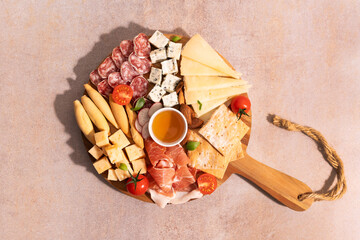 Top view of an elegant cheese and meat platter arrangement