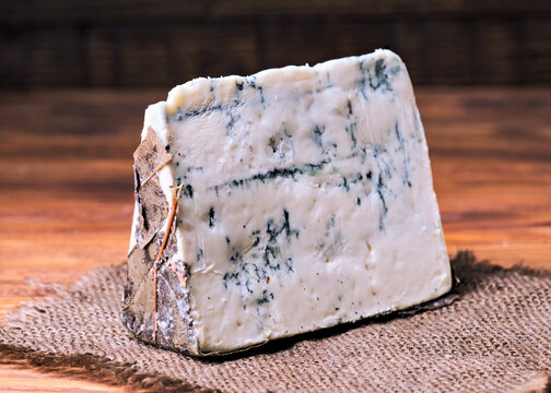 Rustic blue cheese piece on burlap background