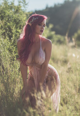 Sensual elven maiden redhead in a field