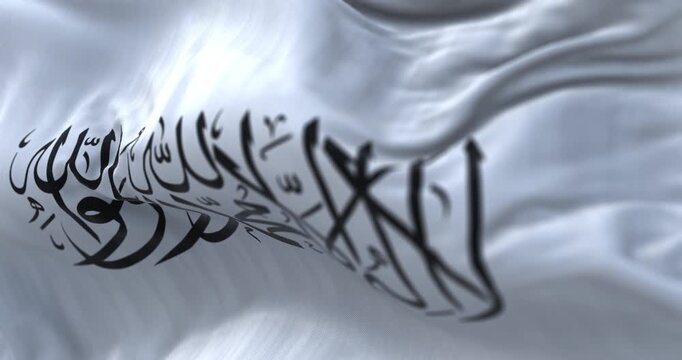 The flag of the Islamic Emirate of Afghanistan waving in the wind.