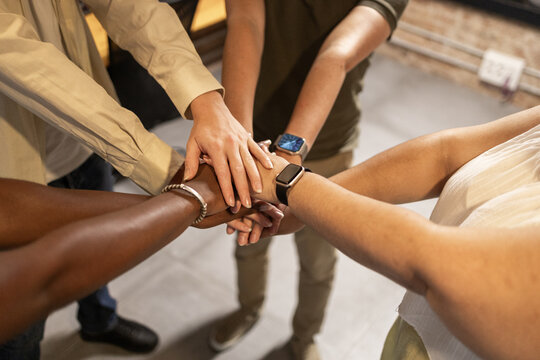 Teamwork with hands joined in unity