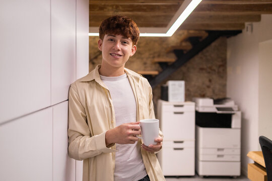 Young professional enjoying a coffee break in office