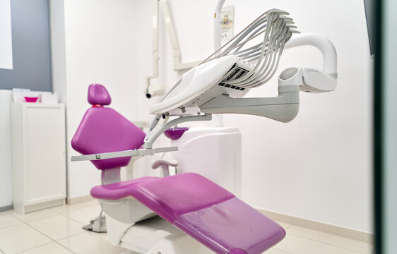 Modern dental clinic with purple dental chair