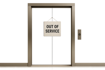 Open elevator shaft with out of service hanging sign on gray wall, minimalist setting