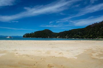 Serene Beach Landscape with Turquoise Waters and Green Hills