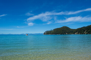 Serene Beach with Turquoise Waters and Distant Boat