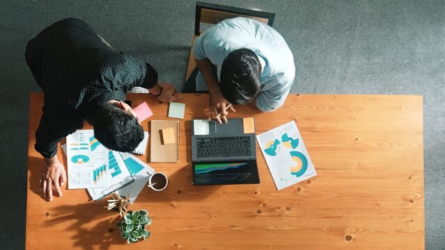 Time lapse of manager walking at table while colleagues brainstorm idea. Business team working together to plan marketing strategy while looking at data analysis or financial statistic. Convocation. - Powered by Adobe
