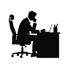 Silhouette of a businessman working at a desk with a laptop