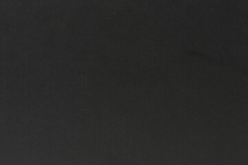 Dark textured surface with subtle variations highlighting its features and depth