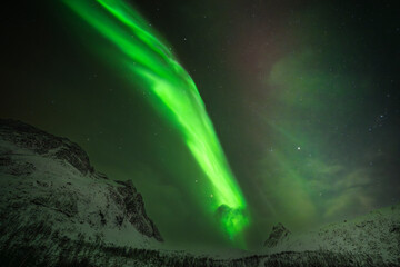 aurora above snowy mountain peak