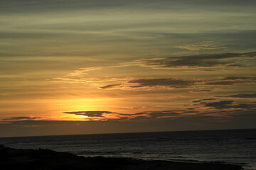 Golden sunset casting a warm glow over the seaside horizon at Longgang Miaoli Taiwan, captured in summer 2011 for a tranquil scene.