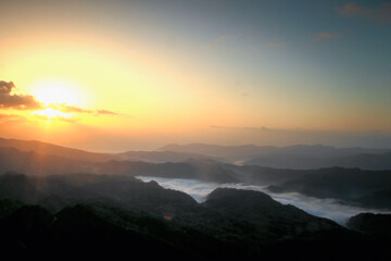 Breathtaking sunrise view from Wufenshan Mountain in New Taipei City, Taiwan, with layers of misty clouds filling the valleys below, creating a serene and beautiful landscape.