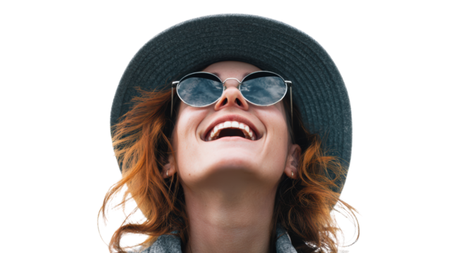 Happy woman smiling with sunglasses and wide-brimmed hat, isolated on white background.