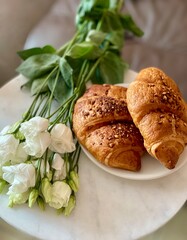 Fresh croissants and lisianthus flowers