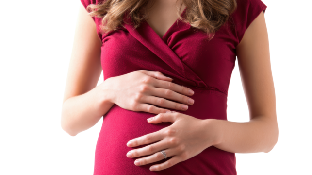 Pregnant woman in a red dress gently cradling her belly with an intimate smile.