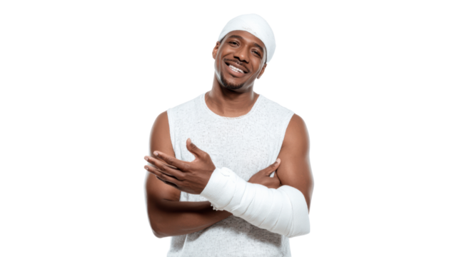Smiling man with a bandaged arm in athletic wear, expressing positivity and resilience.