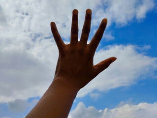 Hand Reaching Towards the Sky