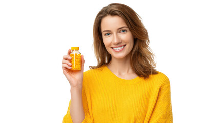 Smiling woman in yellow sweater holding a jar of vitamins with cheerful expression and white isolate background.