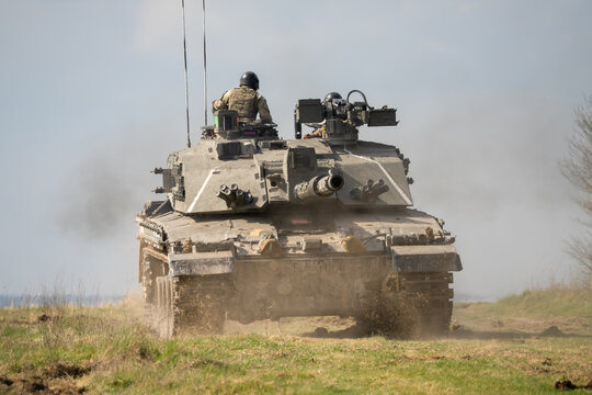 commander and gunner directing a Challenger II 2 FV4034 main battle tank on a military exercise 