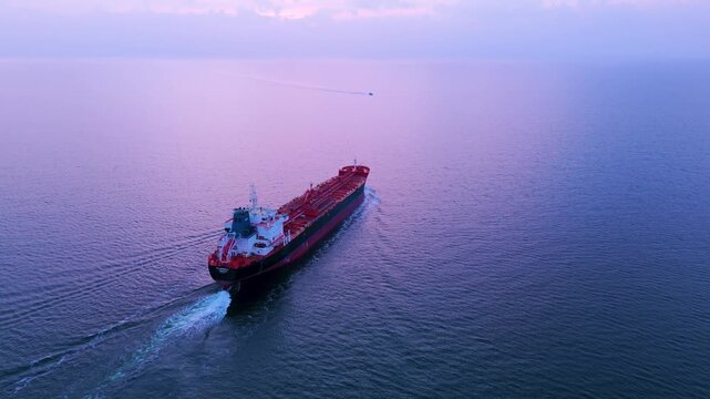 Aerial view of an oil tanker at sea during blue hour at sunset