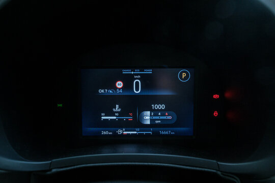 Vehicle display panel showing car speed at 0 km/h engine RPM at 1000 and distance at 16667 km Car in parking mode with parking brake activated