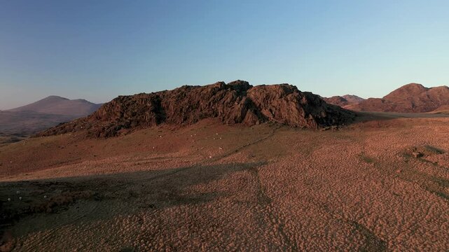 Lake District National Park, England. N. over Eskdale to central fells of L-R Sca Fell, Esk Pike, Bow Fell, Crinkle Crags, Harter Fell from near Devoke Water. Spring evening. 4k video fly in up 