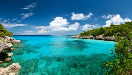 Fototapeta premium serene turquoise bay clear water lush greenery rocky shores and fluffy clouds