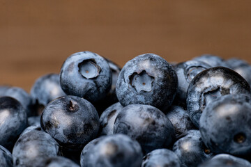 Fresh ripe blueberries close up with natural texture and bloom. Organic fruit and healthy food concept. Macro shot photography.