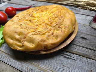 baked flat bread with cheese on a wooden plate