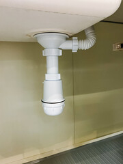 A sink features a securely fastened drain pipe, which is an essential component of the plumbing system in homes or in any other types of structures where it is installed and actively used