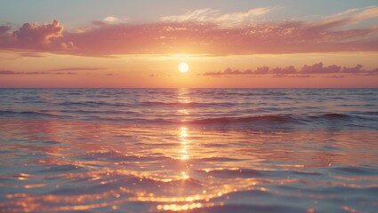 Obraz premium Sunset over the water with the sun reflecting on the surface and clouds in the sky.