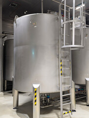 Stainless Steel Industrial Tank With Ladder In Factory Setting