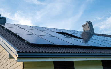 Modern Residential Roof with Solar Panels under a Bright Sky